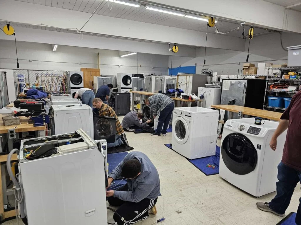 Total Appliance Repair Service technician repairing a home appliance in Abu Dhabi